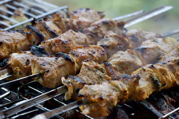 shish kebab on skewers is fried on the grill