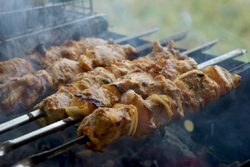 shish kebab on skewers is fried on the grill