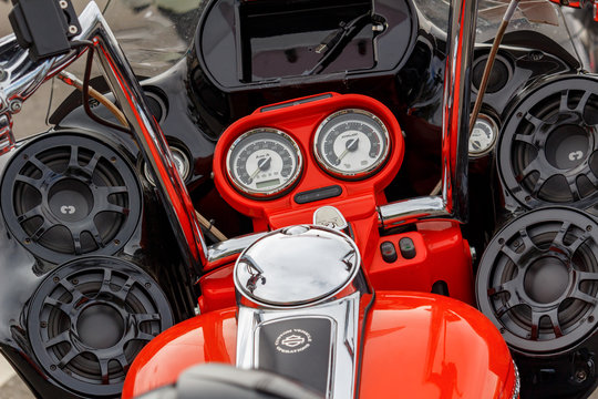 Moscow, Russia - May 04, 2019: Bright orange painted Harley Davidson motorcycle with a power speakers of multimedia system closeup