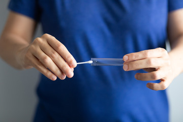 Doctor inserts a saliva sample in the test tube - obrazy, fototapety, plakaty