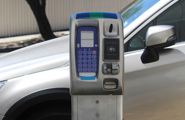 Top of a new digital coin and card operated parking meter with a parked car in background. Sydney