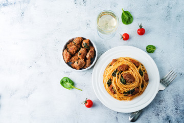 Tomato Spinach Sausage Pasta in a white plate