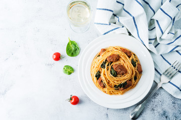 Tomato Spinach Sausage Pasta in a white plate