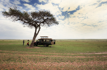  Tourists enjoying food in the mid of game drive in Masai Mara National Reserve