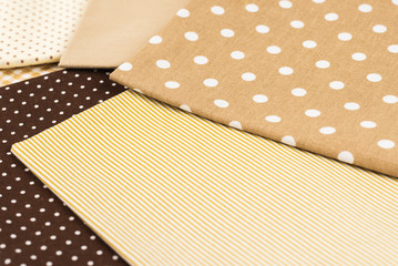 Mix of beige, white and brown cotton fabric.