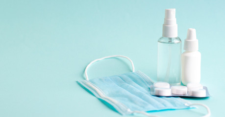 Pills, tablets and bottle on turquoise background. Copy space