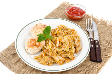 Homemade soy cutlets, fried cabbage on plate.