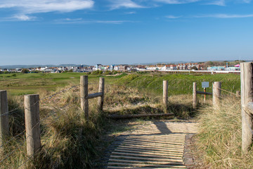 Footpath over the dunes on west bank with Littlehampton in the background and also part of the Littlehampton links golf course.