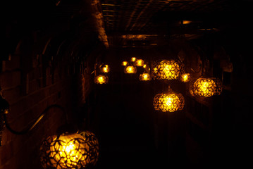 The image of a lamp in a restaurant. Yellow decorative plafonds
