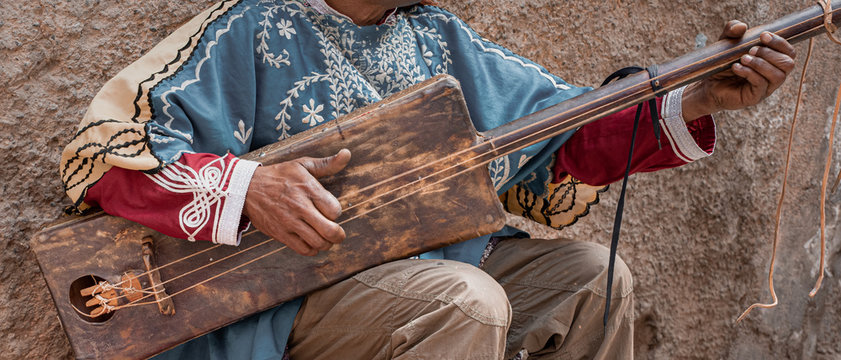 Moroccan musician playing guitar from Morocco, gumbri, guembri or hajhouj, Marrakech
