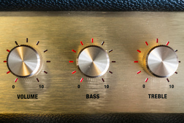 knobs of guitar amplifier in gold