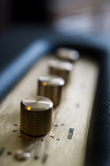 knobs of guitar amplifier in gold