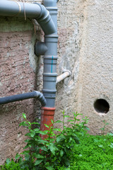Toilet drainage pipes on an old wall