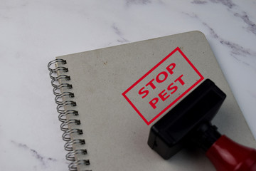 Red Handle Rubber Stamper and Stop Pest text isolated on White Background.