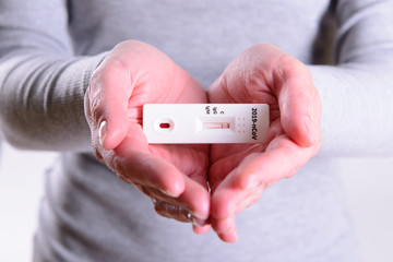 Rapid Covid-19 coronavirus strip test cassette for antibody or sars-cov-2 virus disease in hands...