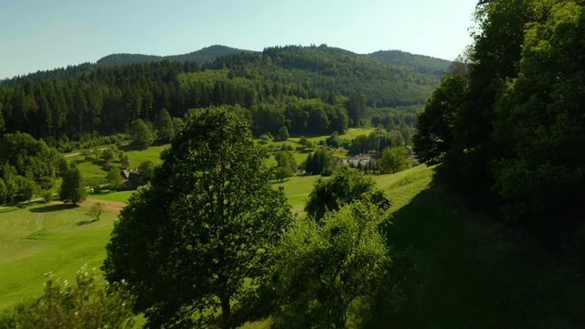 Drone Flight Above Green Field, Village on the Hills in the Middle of the Black Forest
