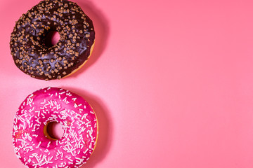 Fresh glazed donuts isolated on a pink background