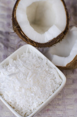 Coconut, coconut shavings and coconut milk on a black background. 