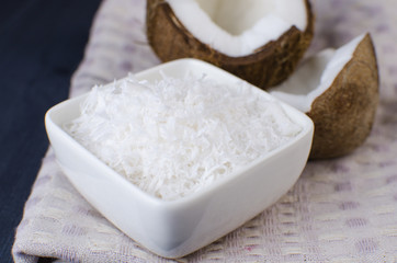 Coconut, coconut shavings and coconut milk on a black background. 
