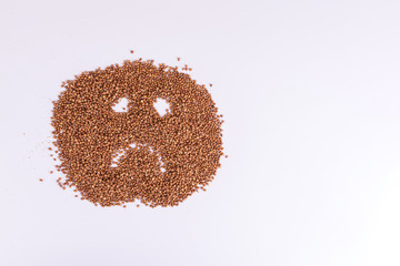 Sad buckwheat cereals emoji on white. Sad grain smile