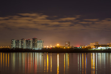 Fototapeta na wymiar Night city lights reflected in the river. Nizhny Novgorod, the river Oka.