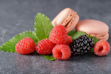 Fresh berries with french macarons and melissa leaves
