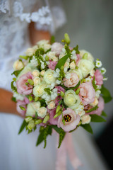 wedding bouquet in the hands of the bride