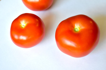 Red and juicy tomatoes on a white background