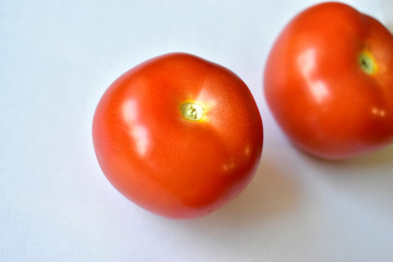 Red and juicy tomatoes on a white background