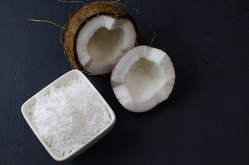 Coconut, coconut shavings and coconut milk on a black background. 