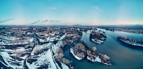Panoramic aerial view: beautiful spring landscape: the Irtysh river in Kazakhstan wakes up from winter sleep - ice drift - snow and ice are melting at sunset