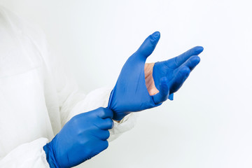 doctor's hands close-up in torn rubber gloves. torn medical gloves after a working day at the...