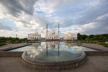 Beautiful white mosque in Bolgar reflected in the water against the backdrop of a beautiful sky
