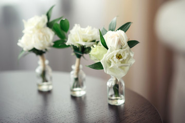 Roses in glass bottles. Wedding decor.