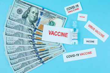 the cost of a coronavirus vaccine. vaccine ampoule on a hundred dollar bill. text. Place for text. the world is waiting for a cure for covid-19. Medicines business
