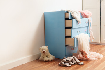 children's things come out of the dresser mess in the room