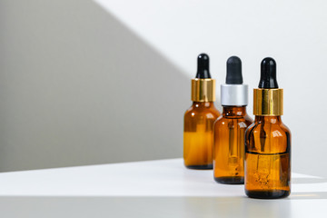 Oily skincare moistrizing brown glass jar with pipette close up