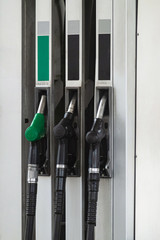 Petrol pump filling nozzles at gas station, nobody. Fuel pumps, self service