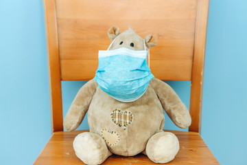 teddy bear and hippo in a medical mask on a blue background. Concept of 2019-20 coronavirus Covid-19 pandemic.
