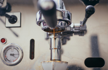Professional coffee machine making espresso in a cafe