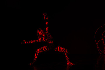 Ballet dancer dancing in front of and red light while expressing the hell with her magnificent...