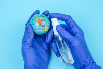 globe in the hands of the doctor. The inhabitants of the planet are fighting the coronavirus. The global pandemic COVID 19. globe in a medical mask.