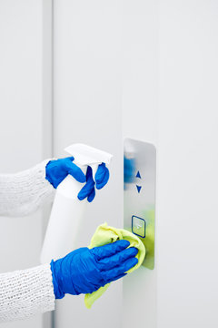 Close up hand of woman disinfecting lift push