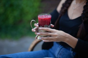
fruit smoothie in glass cups in hands