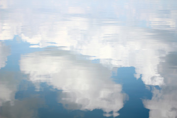 Blue sky with majestic clouds  reflection in water