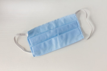 Blue medical mask, medical protective mask on white background. Disposable surgical face mask cover the mouth and nose. Healthcare and medical concept.