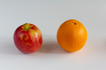 Juicy apple and orange on a white background. vitamin juice