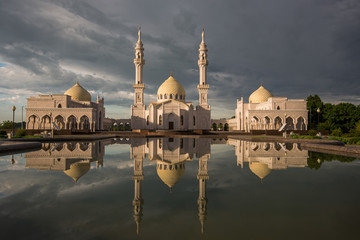 Beautiful white mosque in Bolgar reflected in the water against the backdrop of a beautiful sky