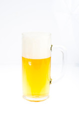 Fresh tasty cold beer with foam in glass on white background.