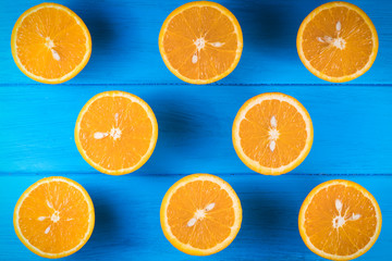 .cut oranges on a blue wooden background